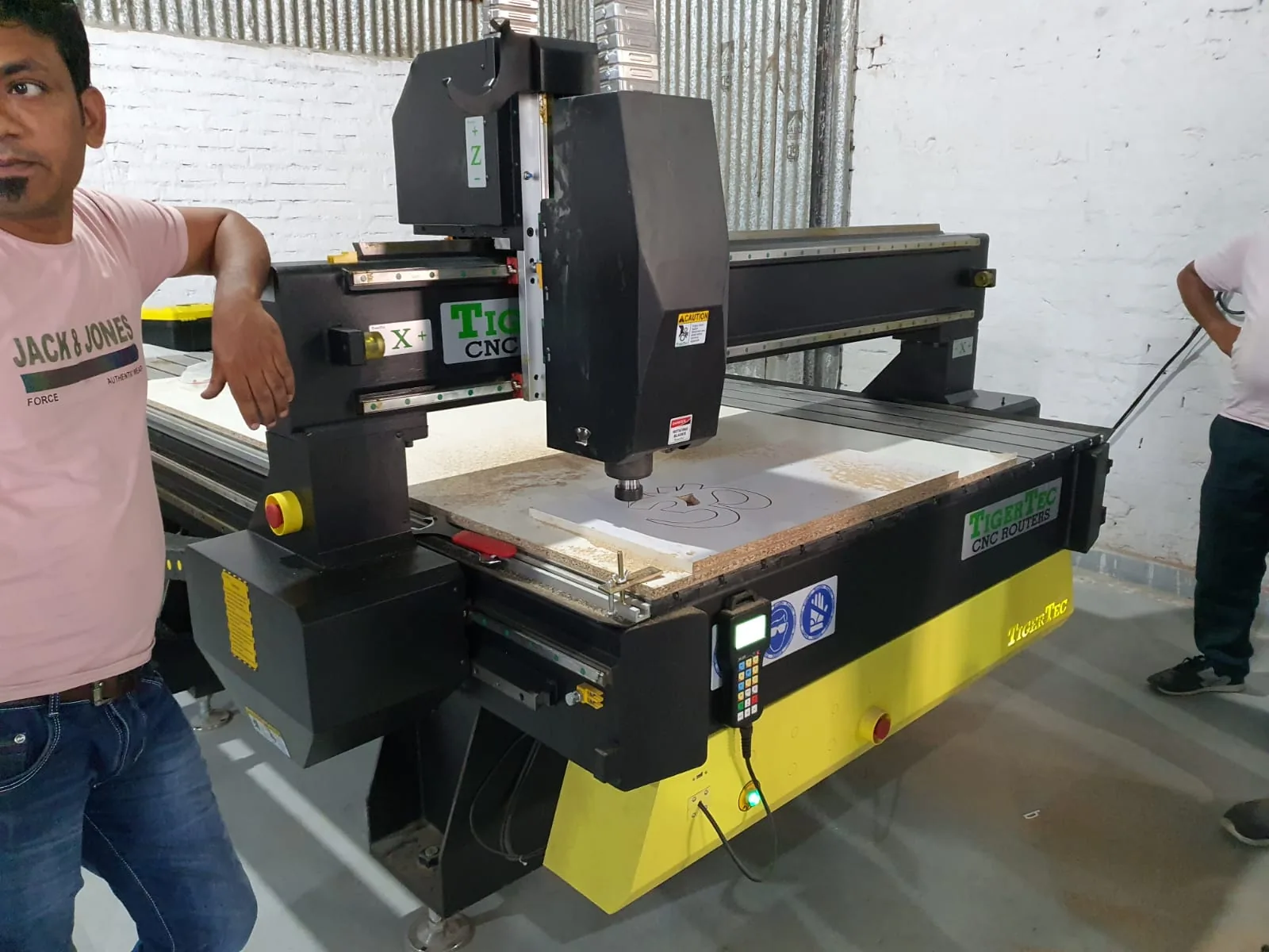 Wood-based board being worked on a CNC router at VM Live